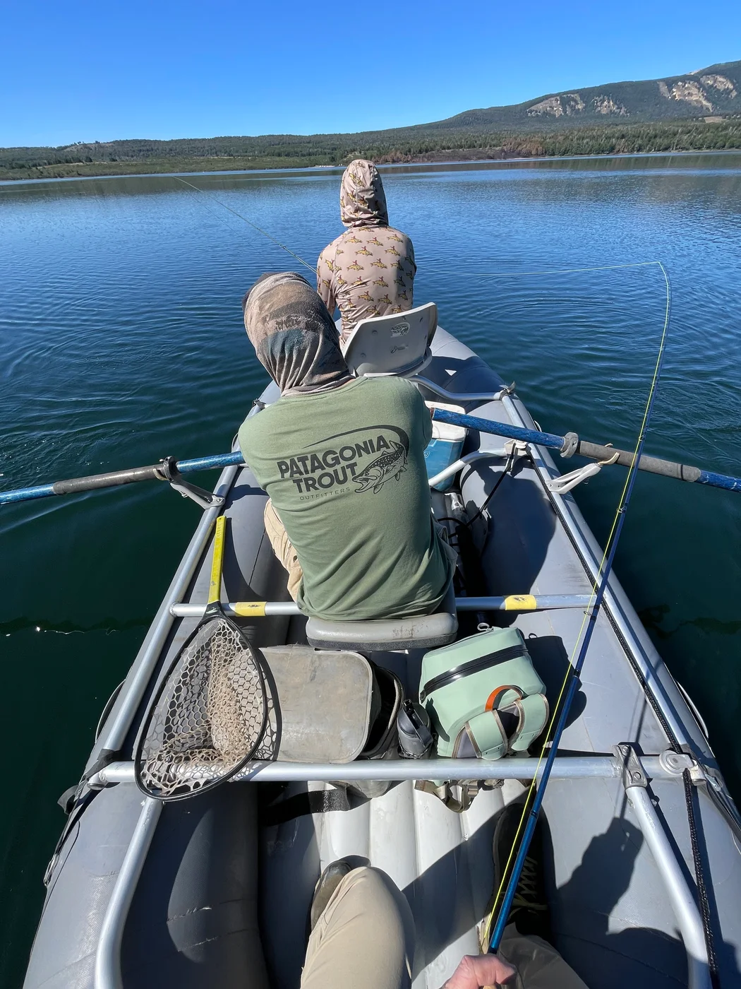 Frame de pesca con remero y pescador navegando en un lago